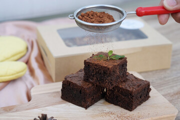 Delicious gooey chocolate brownie on table background and copy space.