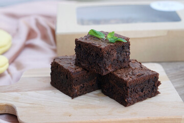 Delicious gooey chocolate brownie on table background and copy space.