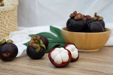 Fresh ripe mangosteen fruits on table and copy space, Thai call Queen of Fruit in Thailand.