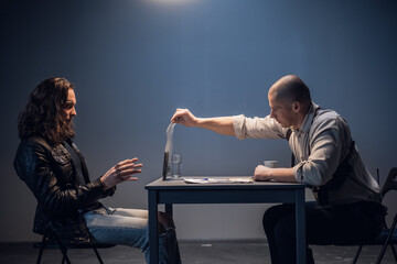 A detained white man with long hair receives irrefutable evidence of his guilt from a criminal...