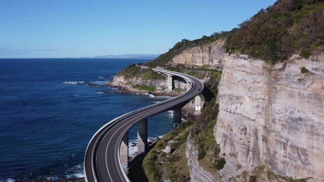 pullback close up aerial clip of sea cliff bridge at stanwell park on the nsw south coast of australia