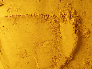 Yellow powder of grated turmeric. View from above.