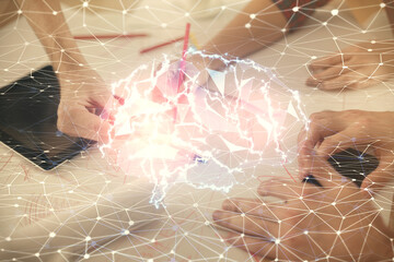 Double exposure of man and woman working together holding and using a mobile device and brain...