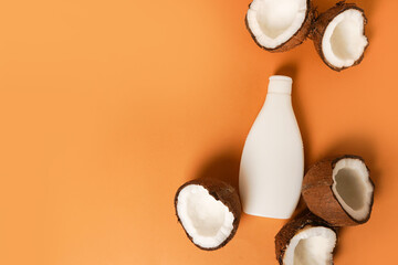 cosmetic bottle and fresh organic coconut for skincare, natural