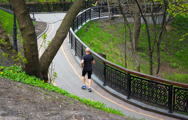 Running man. Back view.Male runner jogging in the park.	
