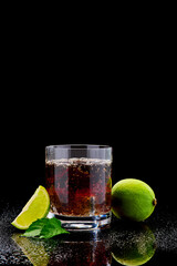 Whiskey with steel cooling cubes on dark glass background