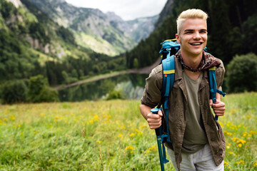 Fototapeta na wymiar Active healthy man hiking in beautiful nature. Outdoor activity, sport conecpt