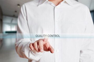 Fototapeta premium Businessman presses quality control button on a virtual touch screen.