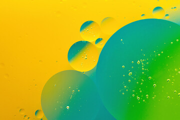 Macro photography of the oil drops on the water surface.Vibrant gradient background.Cosmic circles...