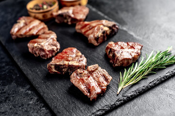several mini Grilled beef T-bone steaks on stone background