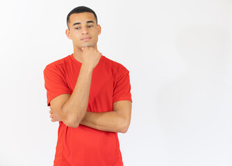 Pensive young man in casual t-shirt isolated over white background