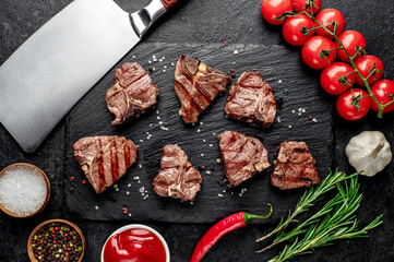 several mini Grilled beef T-bone steaks on stone background