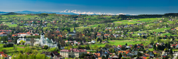 Wide Panoramic View over Monastery and Cityscape of Tuchow,Poland with tatra Mountains Range in Background