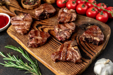 several mini Grilled beef T-bone steaks on stone background
