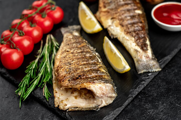 grilled sea bass with spices on a stone background