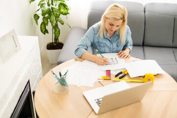 Architect working on blueprint. Architects workplace - architectural project, blueprints, ruler,...