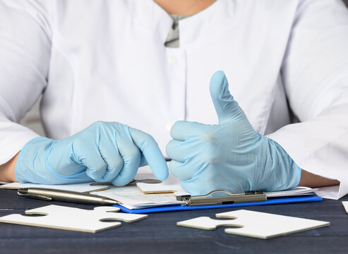 medic woman in white coat showing like gesture in hand, approval concept - Powered by Adobe