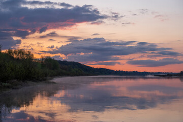Fototapeta na wymiar Dramatic sunrise sky by the river