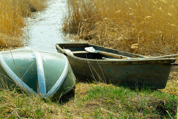 overturned fishing boats in the reeds near the lake