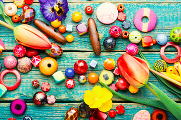 Assorted of colored beads,wooden background