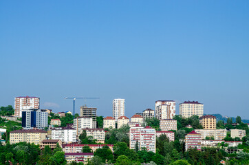 City quarter on a hill. Construction crane