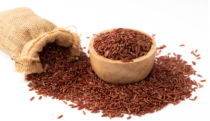 Red rice (brown rice)  in a wooden and sack, Red rice are scattered on the ground.