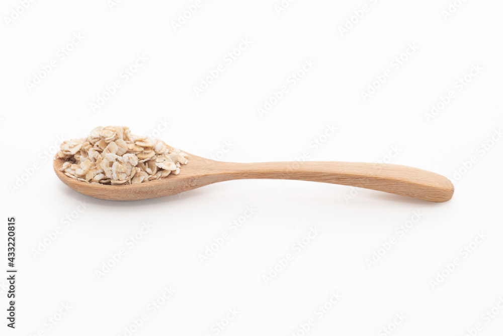 Wall mural 1 spoon of oatmeal isolated on a white background, side view.