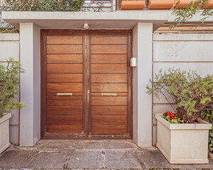 Fototapeta na wymiar elegant house external natural wood double doors and potted plants