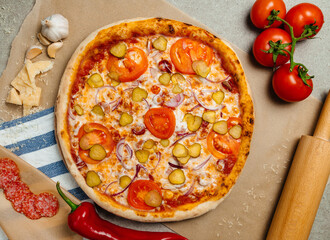 pizza close up. Top view. Italian pizza with vegetables and other ingredients.on parchment paper