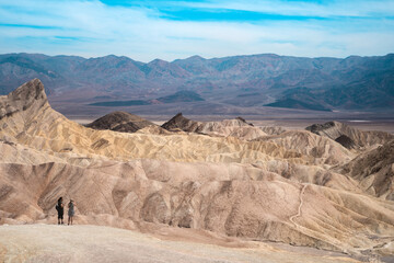 Amazing view of the hills in Zabriskie Point Death Valley National Park, USA. In the distance, small silhouettes of people