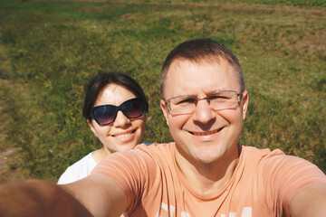 couple making selfie on meadow