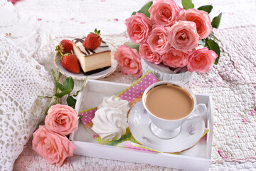 coffee and roses on the bed in romantic style