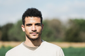 Close-up of a man looking at camera outside