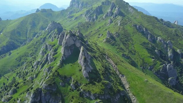 4k aerial drone flight above Ciucas Mountain crests. On the alpine grasslands, eroded calcareous boulders are forming spectacular stone conglomerations. Carpathians, Romania. 