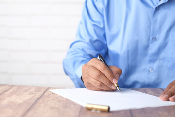 man hand in fountain pen writing or signature on paper .