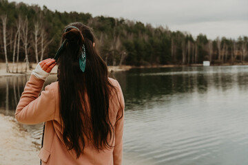 the girl looks into the distance at the lake