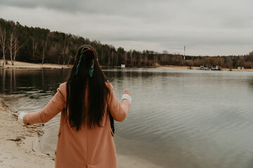 the girl looks into the distance at the lake