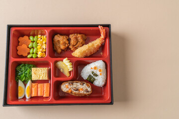 (inari sushi) sushi rice wrapped in dried tofu with fried shrimp and fried chicken in bento set