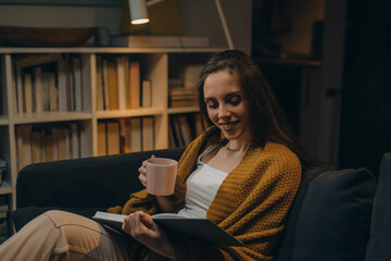 woman reading book at home