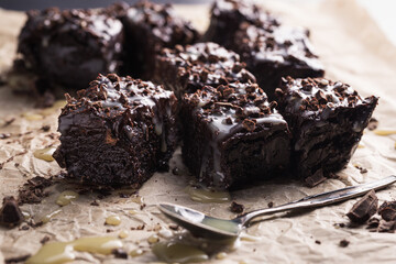 Homemade brownie cake made of dates with chocolate cut into square bars