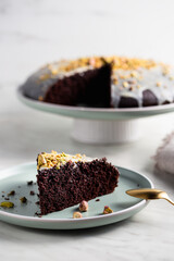 Homemade brownie cake with pistachios in icing.