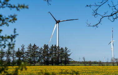 Wind mill in summer landscape with turbine burnt down by fire accident