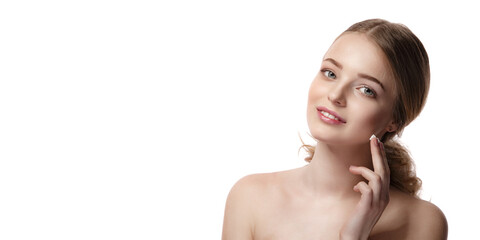 Portrait of young beautiful woman smiling while taking some facial cream isolated on white background with copy space