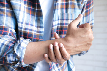 man suffering pain in hand close up 