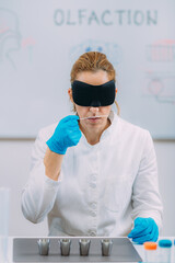 Olfaction. Female Scientist Examining Smells with Mask.