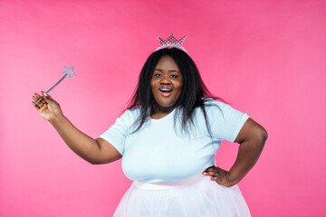 Image of a beautiful woman posing in a fairy costume on a pink background