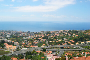 sustainable green city, travel destination funchal city in madeira island with buildings integrated in nature, atlantic ocean on background