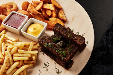 tackler with snacks on black textured background top view