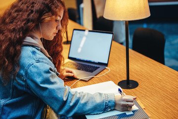 Girl studying alone in library at night