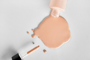 Mockup glass bottle of correction cosmetic product with pipette. Spilled Liquid foundation. Beauty branding concept